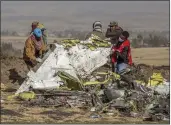  ?? MULUGETA AYENE — THE ASSOCIATED PRESS FILE ?? Rescuers work at the scene of an Ethiopian Airlines plane crash south of Addis Ababa, Ethiopia.