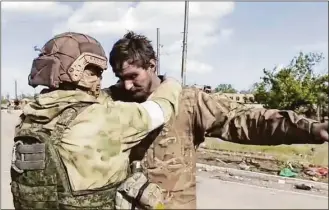  ?? Associated Press ?? In this photo taken from video released by the Russian Defense Ministry, 2022, a Russian serviceman frisks a Ukrainian serviceman after they leaved the besieged Azovstal steel plant in Mariupol, in territory under the government of the Donetsk People's Republic in Ukraine.