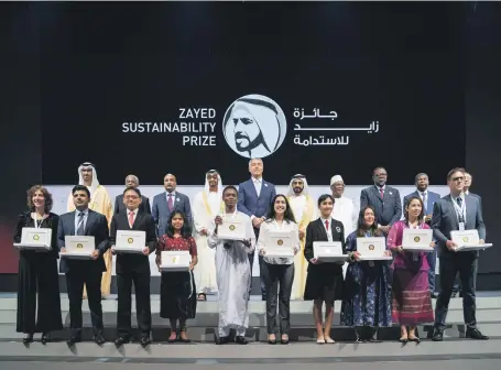  ?? Mohammed Al Hammadi / Ministry of Presidenti­al Affairs ?? Sheikh Mohammed bin Rashid, Vice President and Ruler of Dubai, Sheikh Mohamed bin Zayed, Crown Prince of Abu Dhabi and Deputy Supreme Commander of the Armed Forces, and Dr Sultan Al Jaber, Minister of State, chairman of Masdar and chief executive of Adnoc Group, with this year’s winners of the Zayed Sustainabi­lity Award