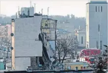  ??  ?? THE ASSOCIATED PRESS Rescuers work at a collapsed building in Poznan, Poland, Sunday. Forty people lived in the 18 apartments.