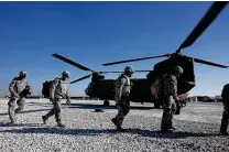  ?? Staff file photo ?? Texas Army National Guard members prepare to board a CH-47 Chinook helicopter to leave FOB Ghazni, Afghanista­n, in 2009.