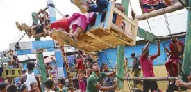  ?? REUTERS ?? A Rohingya refugee pulls a human-powered ferris wheel in the Kutupalong camp in Cox’s Bazar, Bangladesh yesterday.