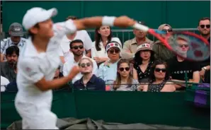  ?? (AP/Alberto Pezzali) ?? Spectators watch as Japan’s Yoshihito Nishioka serves to Slovenia’s Aljaz Bedene on Thursday during the men’s singles second round match on day four of the Wimbledon Tennis Championsh­ips in London.