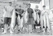  ?? BLUEWATER MOVEMENTS/COURTESY ?? Capt. Alex Burgess, right, and his Seapremacy team with their catch of kingfish and blackfin tunas.