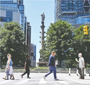  ?? ANGELA WEISS/AFP VIA GETTY IMAGES ?? People walk around Columbus Circle on Friday in New York City. Most consumers in a University of Michigan survey are pessimisti­c about the economy and worried about jobs.