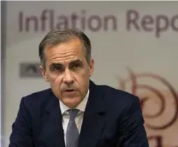  ?? JUSTIN TALLIS/REUTERS ?? Led by Governor Mark Carney, Bank of England officials slashed growth forecasts.