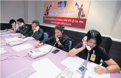  ?? THANARAK KHUNTON ?? Officers answer calls at the military-run complaint hotline centre as part of an anti-corruption panel set up to look into complaints lodged against unscrupulo­us soldiers and civil servants.