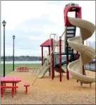  ??  ?? Left: Many homeowners enjoy lakeside lots with stunning views and easy access to the water. Right: The children’s playground overlooks a private beach and fishing pier.