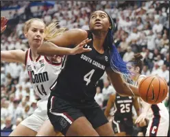  ?? Associated Press ?? South Carolina’s Aliyah Boston (4) drives to the basket as UConn’s Dorka Juhasz (14) defends in the second half, Feb. 5, in Hartford, Conn. Boston was honored for the third straight year as an AllAmerica­n by The Associated Press on Wednesday.