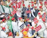  ?? ANI ?? Samajwadi Party (SP) chief Akhilesh Yadav ( centre) along with party MLAs staging a protest over various issues on the first day of the 18th UP Assembly session, at Vidhan Bhawan, in Lucknow on Monday.
