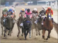  ?? Mark Lennihan / Associated Press ?? Justify, right, leads the field at the end of the backstretc­h during the Belmont Stakes on Saturday.