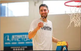  ?? SUBMITTED PHOTO/COURTESY OF SWARTHMORE ATHLETICS ?? Swarthmore’s Vinny DeAngelo cuts down the net after leading the Garnet to the Centennial Conference championsh­ip.