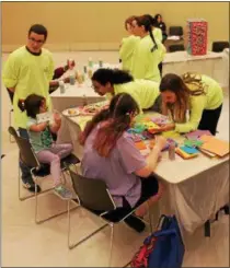  ??  ?? Volunteers doing arts and crafts activities with event-goers at the sixth annual Autism Expo and Art Exhibit, held Sunday afternoon at the Saratoga Springs City Center.