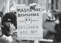  ?? Cheney Orr / Bloomberg ?? Student walkouts, such as this one in Chicago and the smaller ones in Round Rock, show desperatio­n. The fight against COVID is unwinnable, but students are right that schools could be safer.