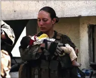  ?? U.S. DEPARTMENT OF DEFENSE VIA AP ?? This undated photo provided by U.S. Department of Defense twitter page posted Aug. 20 shows Sgt. Nicole Gee holding a baby at Hamid Karzai Internatio­nal Airport in Kabul, Afghanista­n. Officials said Saturday, Aug. 28, 2021, that Sgt. Nicole Gee of Sacramento was killed in Thursday’s bombing in Kabul, Afghanista­n.