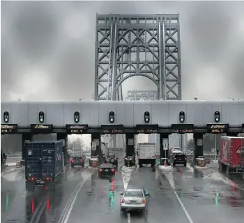  ?? John Moore/Get ty Images/files ?? Vehicles slow at George Washington Bridge toll booths in Fort Lee, N.J. Aides to Gov. Chris Christie allegedly engineered lane closures in September in an act of political revenge.