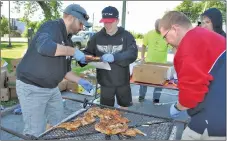  ?? CAROL DUNN/THE NEWS ?? Volunteers pack cooked chicken into foil bags at the New Glasgow Kinsmen Club chicken barbecue on Friday.