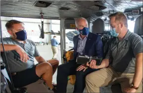  ??  ?? The Canadian Press
Conservati­ve Leader Erin O’Toole chats with Air Force veterans Parker Horton, right, and Matt Wallace as he checks out their Bell 412 helicopter in Sydney, N.S., on Friday.