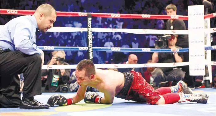  ?? (AP FOTO) ?? AXED BY THE AXE MAN. Nonito Donaire Jr. scrambles to get up after absorbing Nicholas Walter’s uppercut in their WBA featherwei­ght match.
