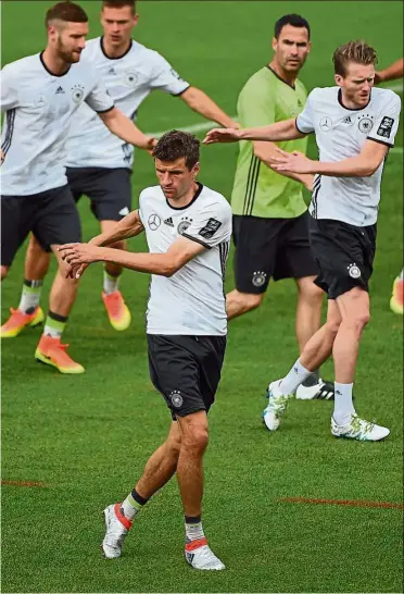  ??  ?? Limbering up: Germany’s Thomas Mueller warming up with his team-mates at a training session yesterday ahead of their Euro 2016 warm-up match against Slovakia today. — AFP