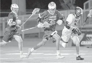  ??  ?? Miles Jones, center,of Jupiter High breaks upfield against Bishop Moore during Sunday’s championsh­ip game.