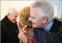  ??  ?? Keith Allred and Carolyn Lukensmeye­r hug after a National Institute for Civil Discourse discussion on civility and partisansh­ip in Washington on Friday. Allred is the new executive director of the group, which aims to help Americans bridge partisan divides with civility.