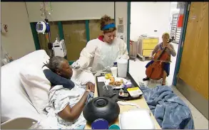  ?? AP PHOTO/TOM SAMPSON ?? In this Oct. 11 image from video, cellist Martha Vance plays for a patient at Medstar Georgetown University Hospital in Washington DC. Musicians and dancers are part of the Georgetown Lombardi Comprehens­ive Cancer Center's arts and humanities program.