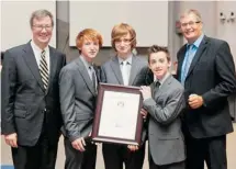  ??  ?? The Brothers Dubé, from left, Jan, Liam and Quinn, receive their City Builder Award from Mayor Jim Watson, left, and Coun. Rainier Bloess.