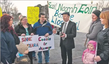  ??  ?? Michael Healy Rae, TD, talks to the groups from three schools, Fybough, Castledrum and Lis Póil that protested in front of Kerry County Council buildings in Rathass, Tralee, on Monday.