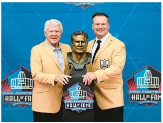  ?? DAVID DERMER/AP ?? Former NFL player Zach Thomas, right, poses with his former coach Jimmy Johnson and his bust during his induction into the Pro Football Hall of Fame on Aug. 5 in Canton, Ohio.