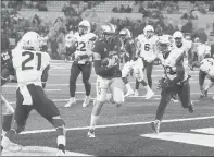  ?? STEPHEN PINGRY/AP ?? Tulsa quarterbac­k Seth Boomer runs into the end zone for a touchdown against UConn on Saturday in Tulsa, Okla. Boomer also threw four TD passes as Tulsa scored a TD on seven straight drives.