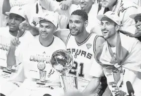  ?? ANDY LYONS/Getty Images ?? Tony Parker, Tim Duncan and Manu Ginobili of the San Antonio Spurs celebrate another
NBA title together after an impressive five-game set with the Miami Heat.