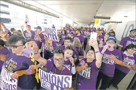  ?? Genaro Molina Los Angeles Times ?? HUNDREDS of airport workers, Uber and Lyft drivers, janitors, government and fast-food workers and others march at LAX in October.