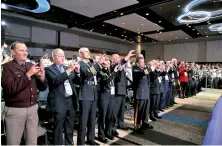  ?? AP PHOTO ?? GRATITUDE: Members of the Internatio­nal Associatio­n of Police Chiefs welcome President Trump yesterday.