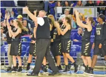  ?? STAFF PHOTO BY TIM BARBER ?? Bradley Central girls’ basketball coach Jason Reuter gives two thumbs up to the student section after the Bearettes won their quarterfin­al against Daniel Boone on Wednesday at Middle Tennessee State University in Murfreesbo­ro. Bradley plays again...