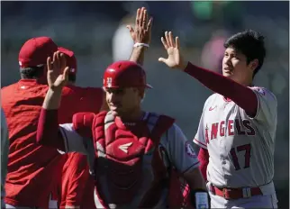  ?? JEFF CHIU – THE ASSOCIATED PRESS ?? Max Stassi, left, and Shohei Ohtani (17) celebrate with teammates after the Angels beat the A’s on Wednesday.