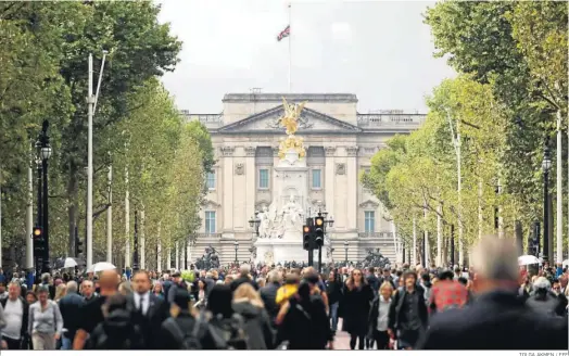  ?? TOLGA AKMEN / EFE ?? Multitud de ciudadanos pasan ante el Palacio de Buckingham, que mantiene la bandera a media asta.