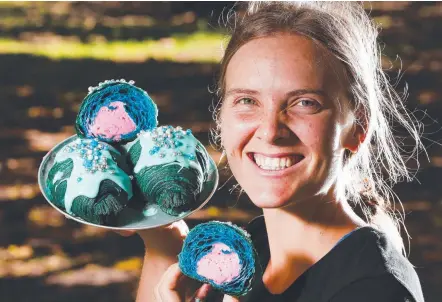  ?? Picture: GLENN HAMPSON ?? Bam Bam Bakehouse staff member Susannah Hunt with the colourful mermaid croissants.