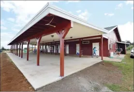  ?? The Maui News MATTHEW THAYER photos ?? The renovated clubhouse includes an expanded outdoor area with covered concrete pad.
Makawao Rodeo bull-riding champion Matthew Gouveia sits on an Oskie Rice Arena fence as he waits for his score in this photo taken in 2014.