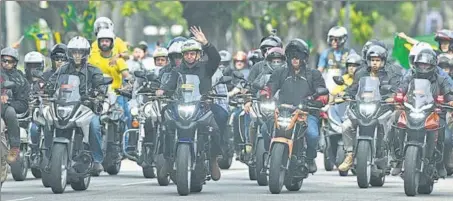  ?? AFP ?? PRESIDENT ON WHEELS: Brazilian President Jair Bolsonaro waves as he heads a massive motorcade rally with his supporters down the streets of Rio de Janeiro on Sunday. His public rallies and motorcades have often been criticised as the country struggles to contain the Covid-19 pandemic.