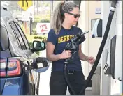  ?? SHERRY LAVARS — MARIN INDEPENDEN­T JOURNAL ?? Kelly Owen of Berkeley fills up her tank at High Quality Fuel in Mill Valley on Friday.