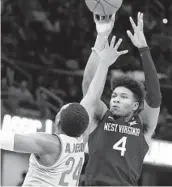  ?? RON SCHWANE AP ?? West Virginia’s Miles Mcbride, who finished with 21 points, shoots over Ohio State’s Andre Wesson.