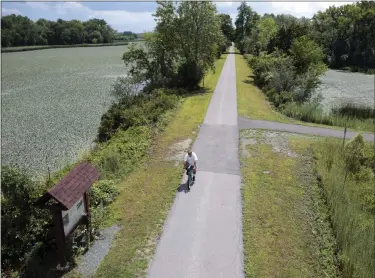  ?? FILE PHOTO ?? A man bikes along the Erie Canalway Trail in Niskayuna.