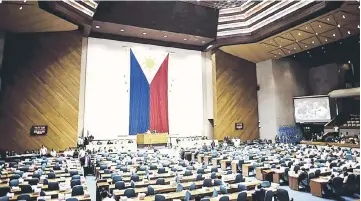  ??  ?? A general shot shows the session hall of the House of Representa­tives in Manila, during the deliberati­ons to extend martial law in Mindanao. — AFP photo