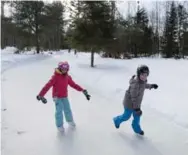  ??  ?? Madeline Rupay, 7, left, and Valerie Belair, 9, enjoy the ice at Patinage en Forêt, which opened just last year.