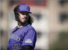  ?? PHOTOS BY AARON ONTIVEROZ — THE DENVER POST ?? Justin Lawrence (61) of the Colorado Rockies stands as his ample flow blows in the breeze during Spring Training at Salt River Fields in Scottsdale, Arizona on Wednesday.