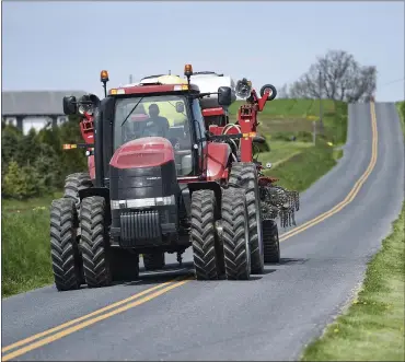  ?? BEN HASTY — MEDIANEWS GROUP ?? Dave Wolfskill drives his Case-IH tractor pulling a corn planter on North Church Street, Lower Heidelberg Township, on April 20 during a Rural Roads Safety demonstrat­ion.