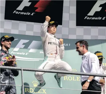  ?? EPA ?? HIGH-FLYER: Nico Rosberg celebrates after cutting the deficit to Lewis Hamilton to nine points in the championsh­ip standings with his win in Belgium yesterday.