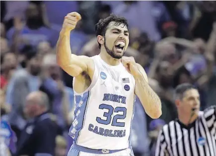 ?? Andy Lyons Getty Images ?? FORMER WALK-ON Luke Maye celebrates after making a 20-footer from the left side with 0.3 of a second left to break a 73-73 tie.