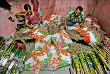  ?? REUTERS ?? Workers making kites with images of Prime Minister Narendra Modi at a workshop for an upcoming kite flying festival in Ahmedabad on Wednesday.